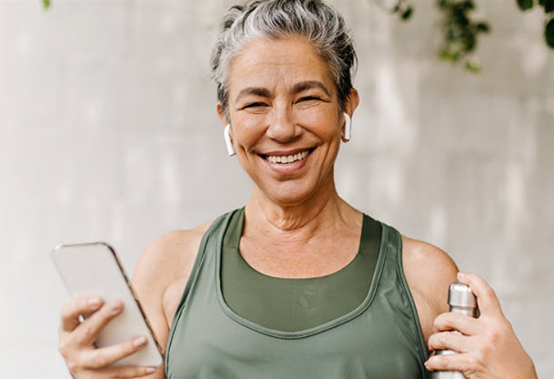 Woman smiling with phone. 