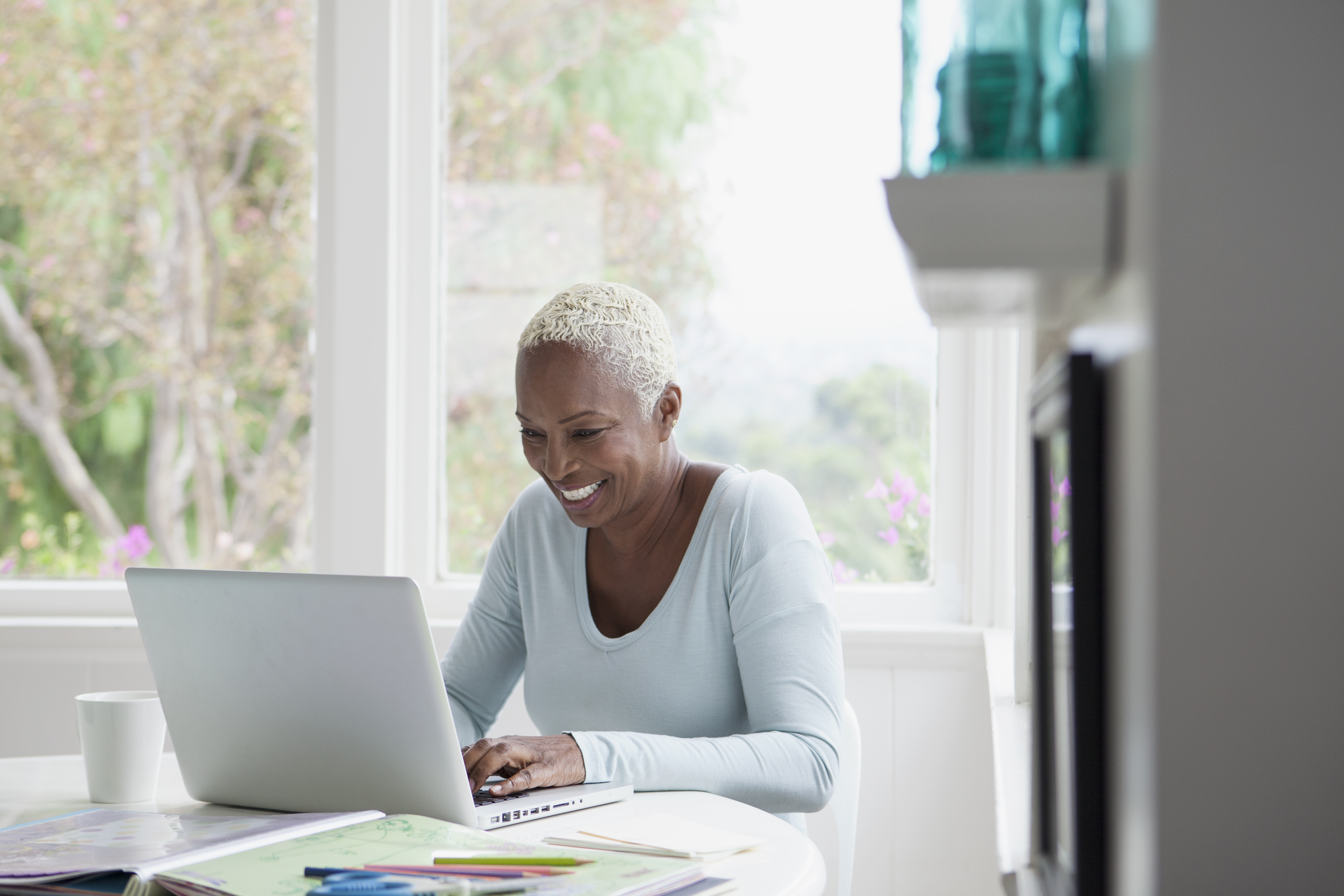 Woman smiling with laptop. 