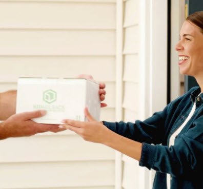 Woman receiving box from HealthBeacon