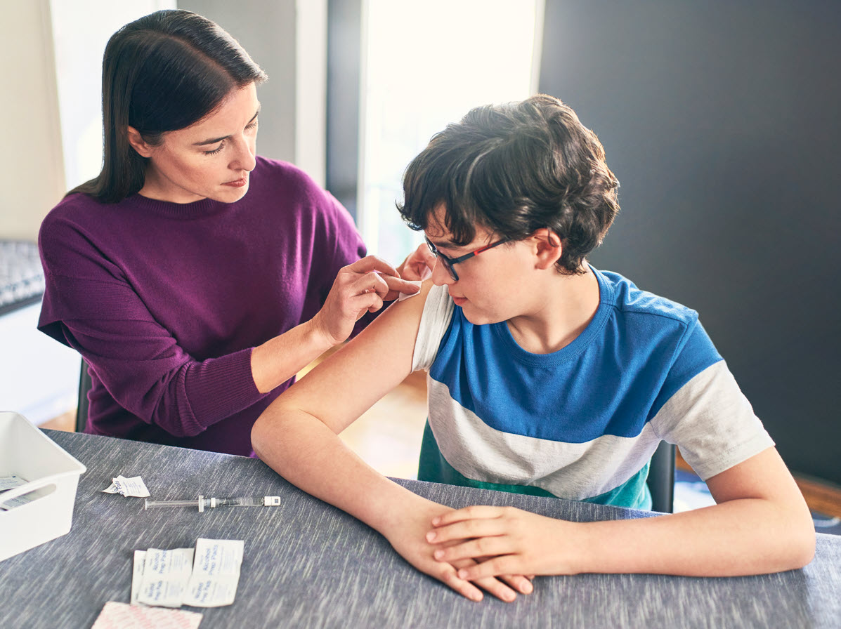 Mother giving son an injection