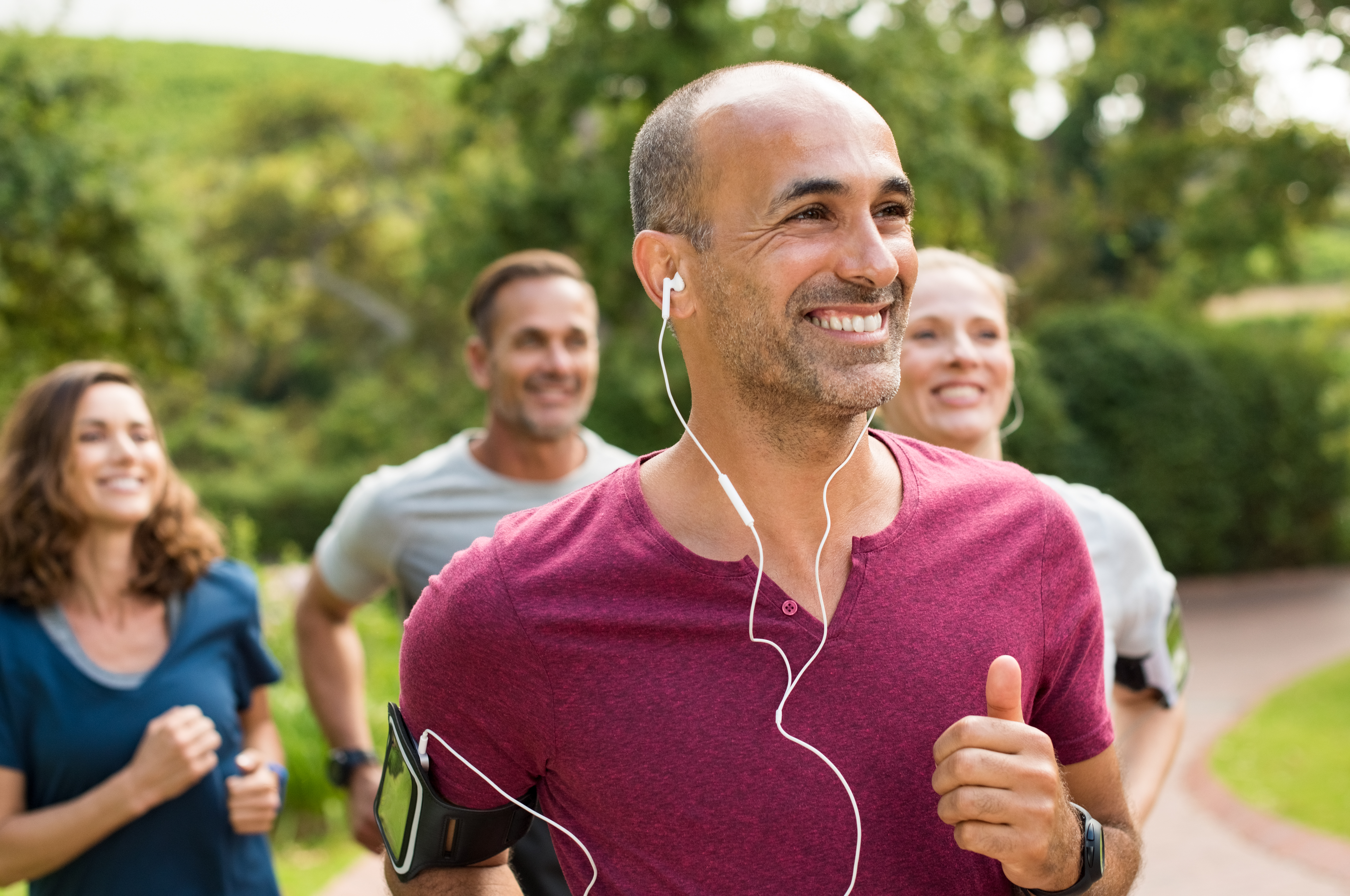 Man running in group and smiling