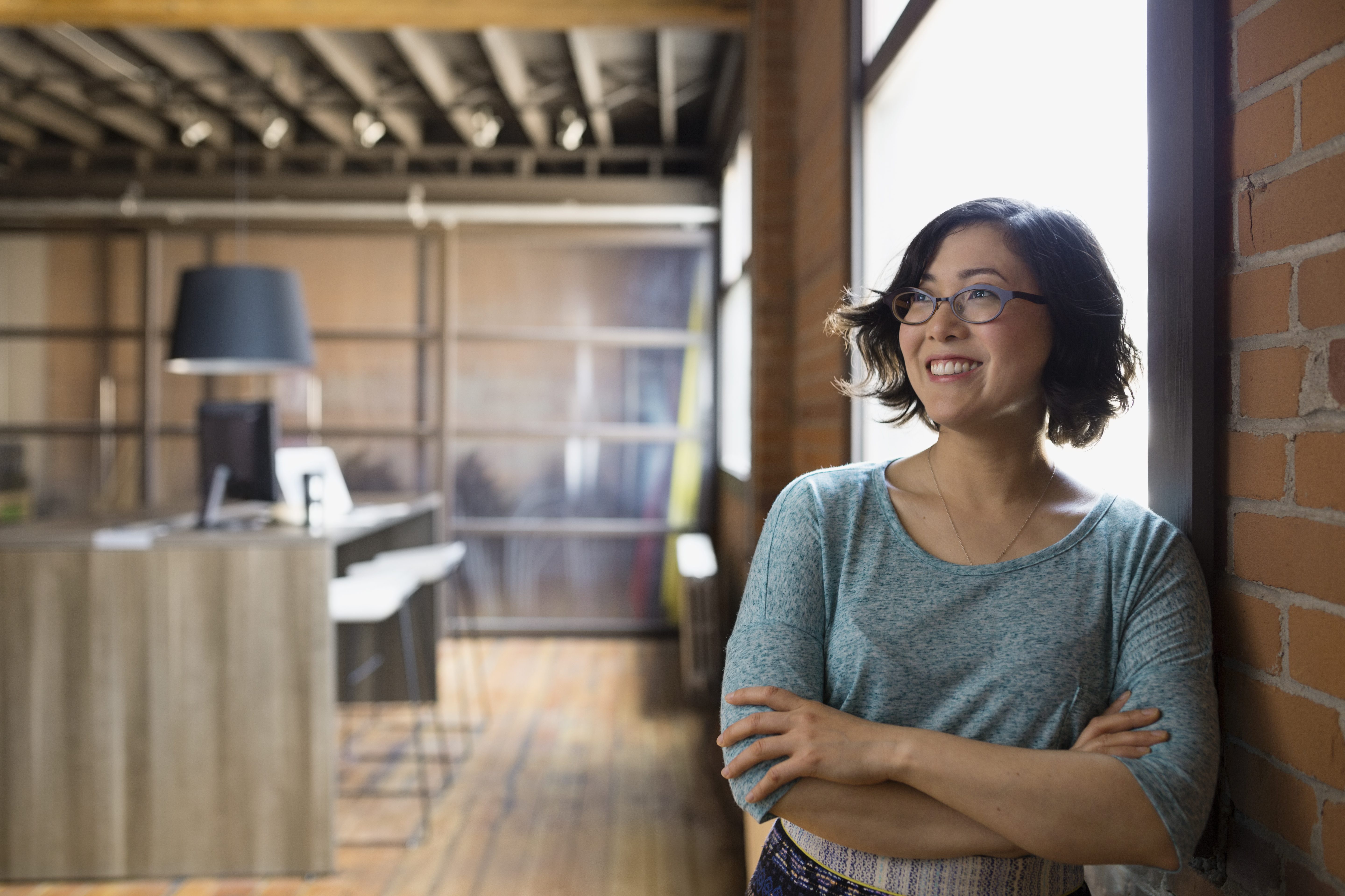 woman smiling with arms crossed