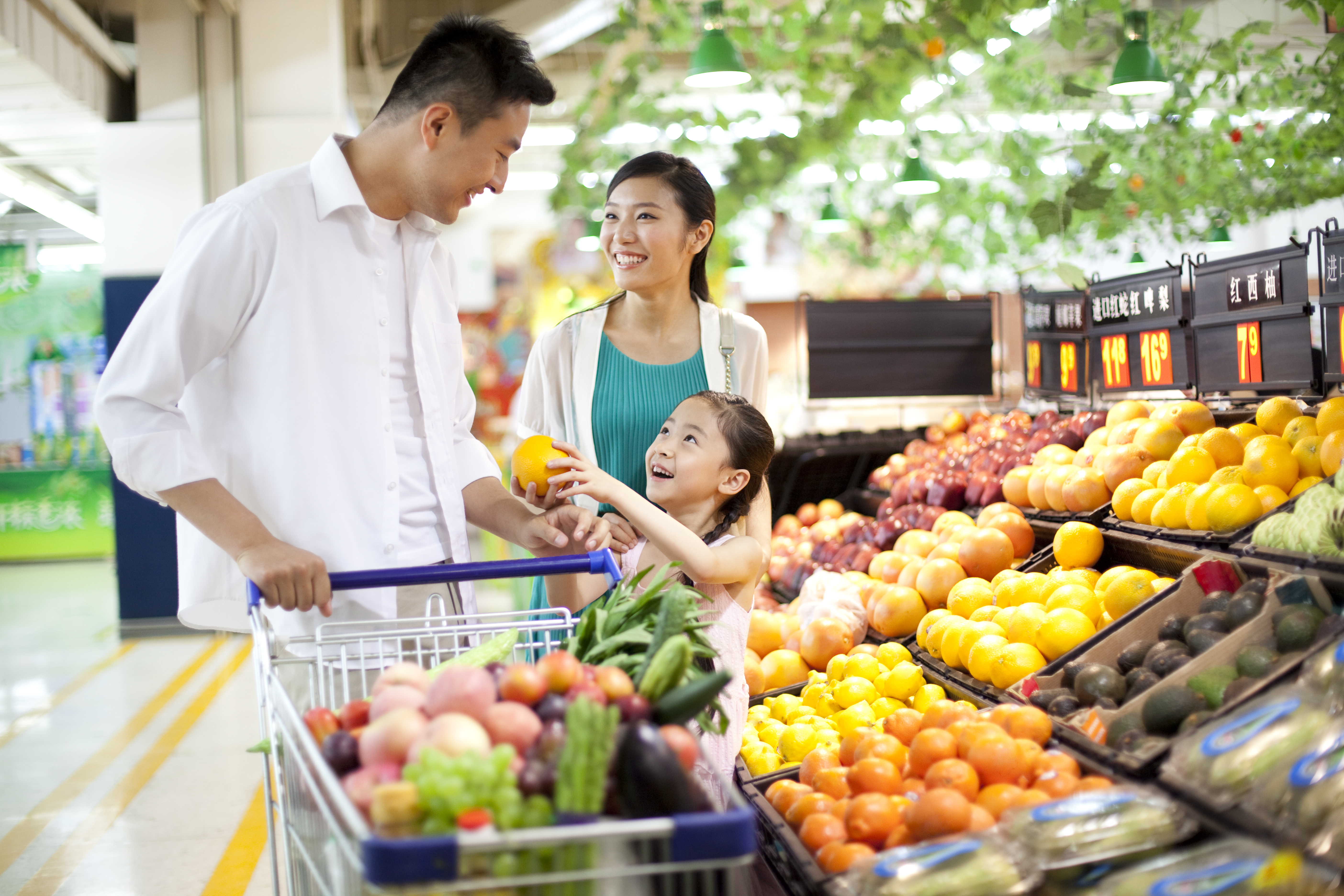 Couple and child grocery shopping