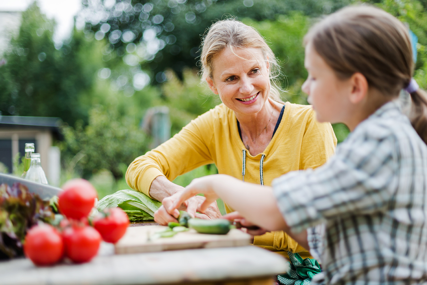 Woman with child eating vegetables