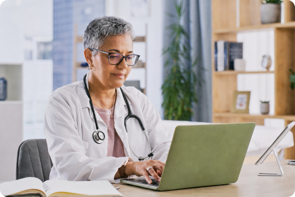 Prescriber typing on laptop