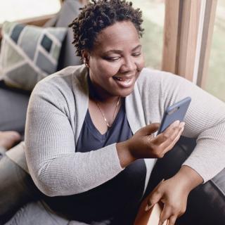 woman on couch looking at phone