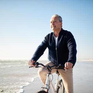 man riding bike on beach